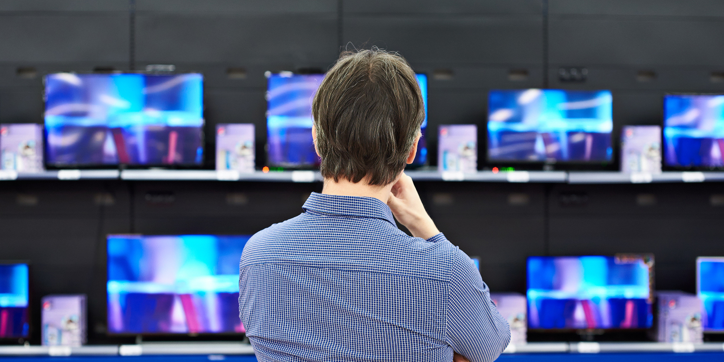 Man looking at TVs